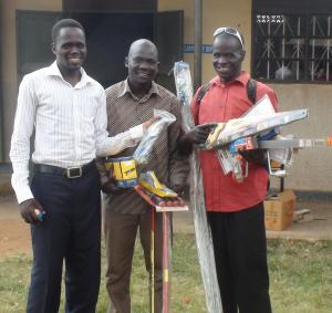 Odong Justine receiving his tools with his brother