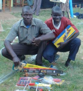 Ojara and Kenneth Pose for a photo with some tools