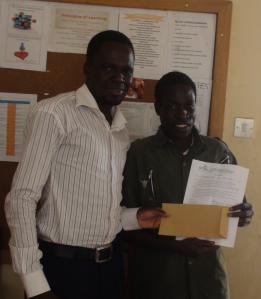 Okwera Geofffrey receiving micro credit